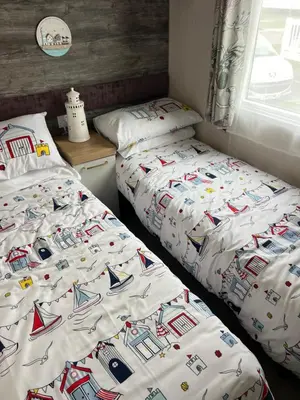 two beds sitting next to each other in a bedroom at Mimosa lodge in Little Clacton