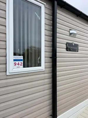 a window on a house with a speed limit sign at Mimosa lodge in Little Clacton