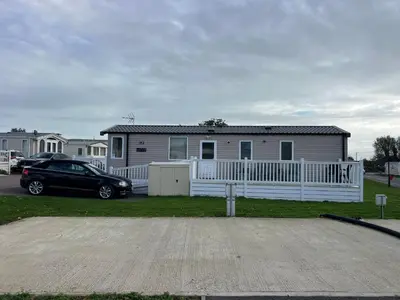 a black car parked in front of a house at Mimosa lodge in Little Clacton