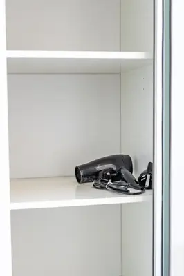 a telephone sitting on a shelf in a cabinet at The Essex Apartments - Ashby House in Chelmsford