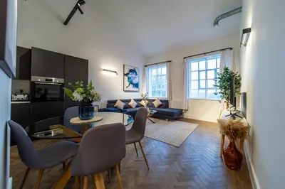 a living room with a couch and a table at The Essex Apartments - Ashby House in Chelmsford