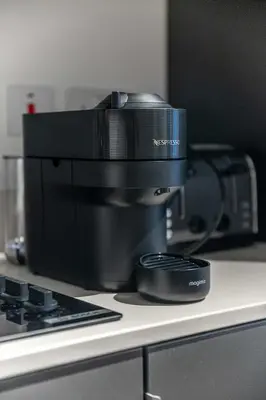 a black coffee maker sitting on top of a counter at The Essex Apartments - Ashby House in Chelmsford
