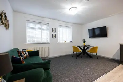 a living room with a couch and a table at Suffolk Square in Sudbury