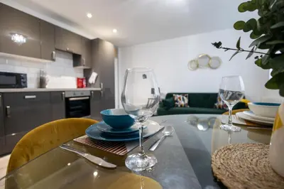 a dining room table with two wine glasses on it at Suffolk Square in Sudbury