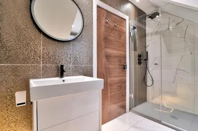 a bathroom with a white sink and a mirror at Stunning large house in Green Dunmow in Felsted