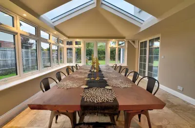 a large dining room with a long table and chairs at Stunning large house in Green Dunmow in Felsted
