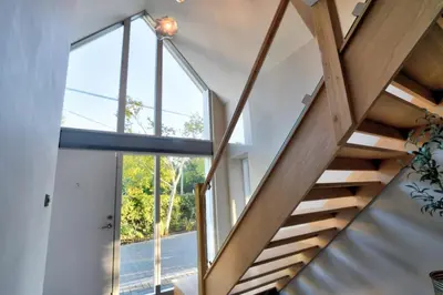 a staircase in a house with a large window at Stunning large house in Green Dunmow in Felsted