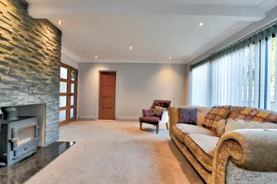 a living room with a couch and a fireplace at Stunning large house in Green Dunmow in Felsted