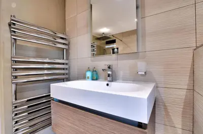 a bathroom with a white sink and a mirror at Stunning large house in Green Dunmow in Felsted