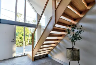 a staircase in a house with a potted plant at Stunning large house in Green Dunmow in Felsted