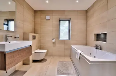 a bathroom with a tub and a toilet and a sink at Stunning large house in Green Dunmow in Felsted