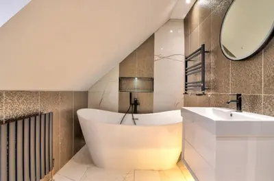 a bathroom with a tub and a sink and a mirror at Stunning large house in Green Dunmow in Felsted