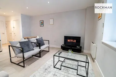 a living room with a couch and a fireplace at Library House Apartments - FREE PARKING - Contractor Hub - Superfast Wi-Fi - Long Term Stays in Brentwood