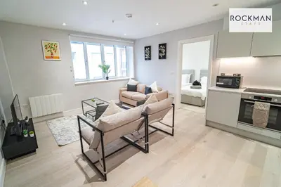 a living room with a couch and a table at Library House Apartments - FREE PARKING - Contractor Hub - Superfast Wi-Fi - Long Term Stays in Brentwood