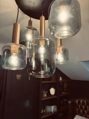 a chandelier with many glass bottles on a ceiling at The Green Scholar's Nook in Cambridge