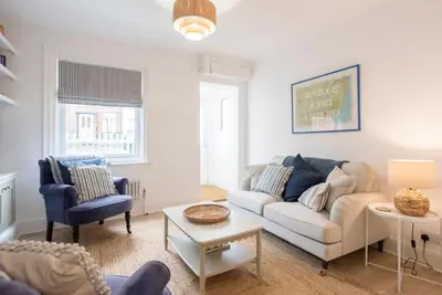 a living room with a couch and two chairs at Millicent Cottage, Aldeburgh in Aldeburgh