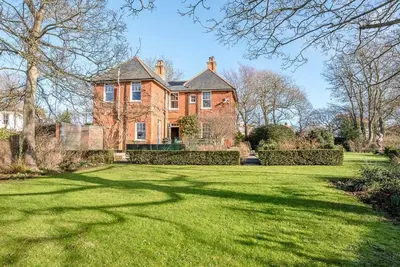 a large brick house with a large grass yard at Kingsfield House, Aldeburgh in Aldeburgh