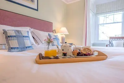 a tray of food on top of a bed at Kingsfield House, Aldeburgh in Aldeburgh