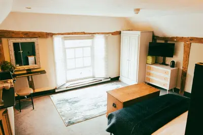 a living room with a large window and a couch at The George in Cavendish