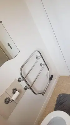 a bathroom with a toilet and a mirror on the wall at Lovely One bedroom flat with free off road parking in Norton