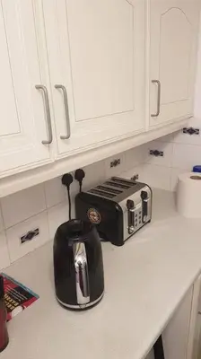 a kitchen counter with a toaster on a counter top at Lovely One bedroom flat with free off road parking in Norton