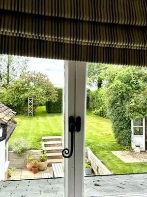 a view of a yard from a glass door at Perfect country cottage retreat! in Fyfield