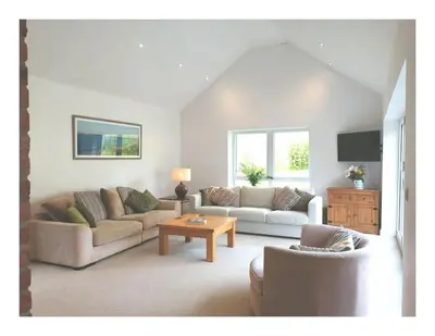 a living room with two couches and a coffee table at The Highlands - 5 bed 5 bath - Huge Sociable House in Exning