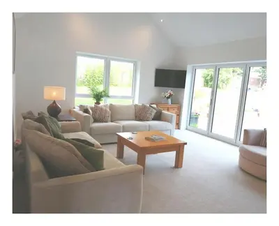 a living room with two couches and a coffee table at The Highlands - 5 bed 5 bath - Huge Sociable House in Exning