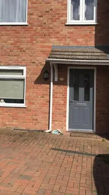 a brick house with a blue door and a brick driveway at Modern house close to amenities St Ives Cambs in St Ives