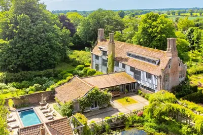 an aerial view of a house with a swimming pool at Spectacular thousand year old Medieval manor house - Flemings Hall in Ipswich