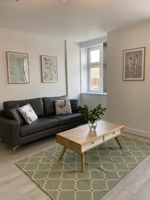 a living room with a couch and a coffee table at Dream Yard Apartments Westcliff in Southend-on-Sea