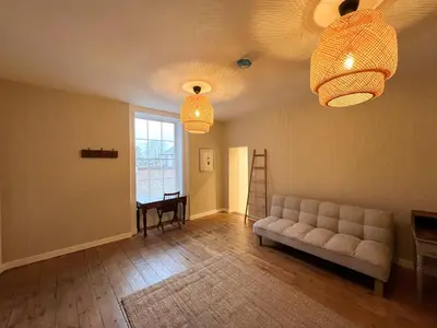 a living room with a couch and two lights at Spacious Suffolk base in Saxmundham