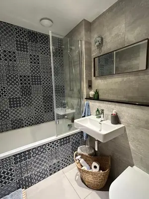 a bathroom with a sink and a shower at Meadow Cottage in Trumpington
