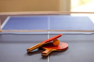 two ping pong paddles on top of a table at Modern Family Home Waltham Abbey Free Parking in Waltham Abbey