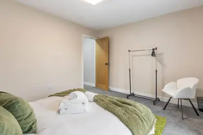 a bedroom with a bed with towels on it at Modern Family Home Waltham Abbey Free Parking in Waltham Abbey