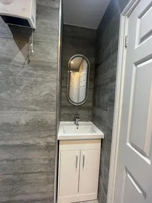 a bathroom with a sink and a mirror at Cozy Studio Flat Romford, London in Romford