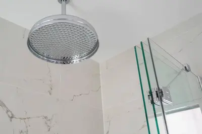 a shower with a shower head in a bathroom at Victoria Cottage in Monks Eleigh