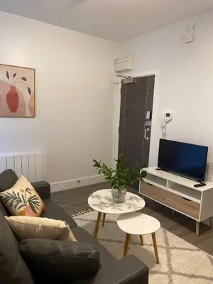 a living room with a couch and a table and a tv at Dream Yard Apartments in Southend-on-Sea