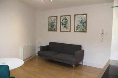 a living room with a couch and a table at East Street Haven - Modern Apartment in Colchester in Colchester