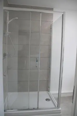 a shower with a glass door in a bathroom at East Street Haven - Modern Apartment in Colchester in Colchester