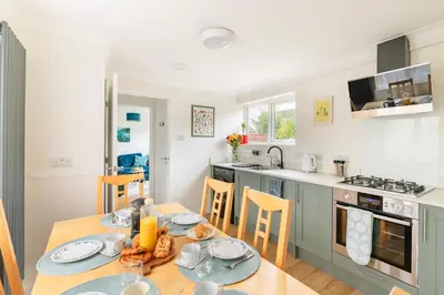 a kitchen and dining room with a table and chairs at Comfortable 4-Bedroom Heaven in Thetford in Thetford