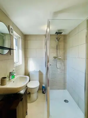 a bathroom with a shower and a toilet and a sink at Stunning 2 bedroom flat for 5 people overlooking the sea 2A in Felixstowe