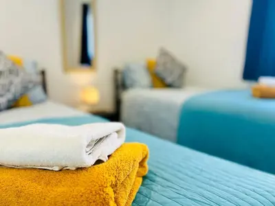 a towel is sitting on a bed in a room at Stunning 2 bedroom flat for 5 people overlooking the sea 2A in Felixstowe