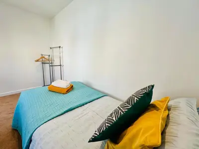 a bed with two pillows on it in a room at Stunning 2 bedroom flat for 5 people overlooking the sea 2A in Felixstowe