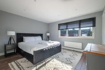 a bedroom with a large bed and a window at 16 Waterloo Close, Newmarket in Newmarket