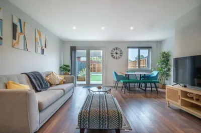 a living room with a couch and a table at 16 Waterloo Close, Newmarket in Newmarket