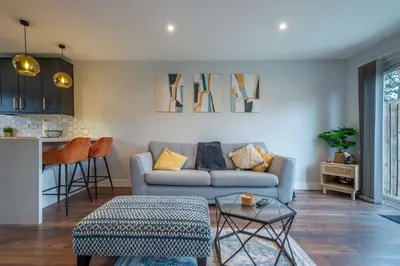 a living room with a couch and a table at 16 Waterloo Close, Newmarket in Newmarket