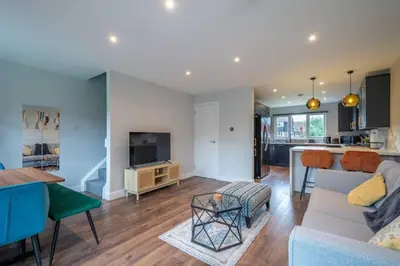 a living room with a couch and a table at 16 Waterloo Close, Newmarket in Newmarket