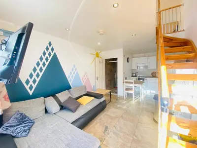 a living room with a couch and a staircase at The Mews Flats - Cambridge, Central Location CB1 in Cambridge