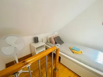 a small room with a bath tub and a fan at The Mews Flats - Cambridge, Central Location CB1 in Cambridge